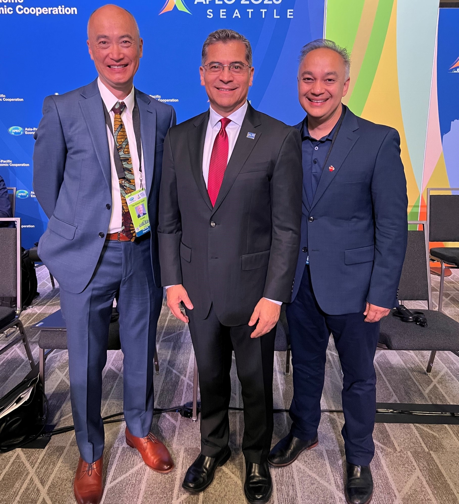 Dr. Shah standing with two other men at APEC event