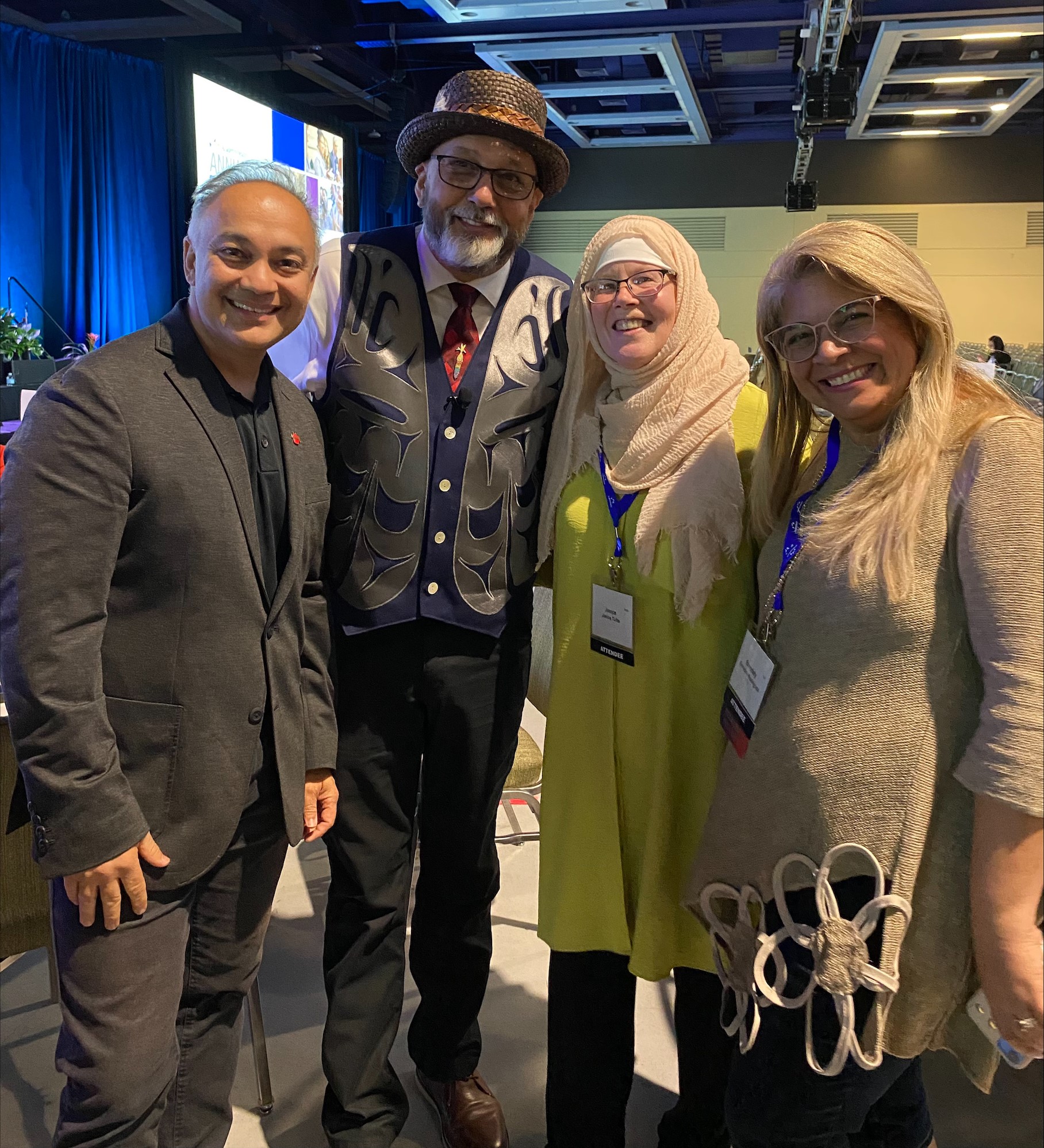 Dr. Shah at event standing with three other people.