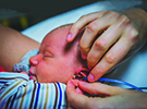 Photo of newborn getting hearing exam