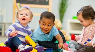 Photo of three diverse children playing together